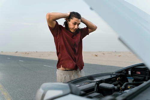 man looking at his broken car man-looking-at-his-broken-car